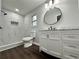 Updated bathroom with marble shower, new vanity, and dark wood-look floors at 7035 Stone Wood Nw Dr, Kennesaw, GA 30152