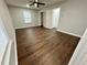 Spacious bedroom with ceiling fan and luxury vinyl plank flooring at 7035 Stone Wood Nw Dr, Kennesaw, GA 30152