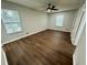 Bedroom with ceiling fan and dark brown luxury vinyl flooring at 7035 Stone Wood Nw Dr, Kennesaw, GA 30152