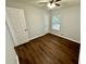 Spacious bedroom with dark brown luxury vinyl plank flooring and ceiling fan at 7035 Stone Wood Nw Dr, Kennesaw, GA 30152