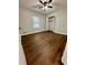 Bright bedroom with dark brown luxury vinyl plank flooring and ceiling fan at 7035 Stone Wood Nw Dr, Kennesaw, GA 30152