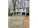 Two-story house with white siding, black accents, and a paved driveway at 7035 Stone Wood Nw Dr, Kennesaw, GA 30152