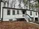 Two-story house with white siding, black accents, and a deck at 7035 Stone Wood Nw Dr, Kennesaw, GA 30152