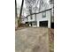 Two-story house with white siding, black accents, and a paved driveway at 7035 Stone Wood Nw Dr, Kennesaw, GA 30152