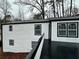 White house exterior with black trim and a large deck at 7035 Stone Wood Nw Dr, Kennesaw, GA 30152