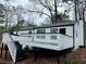 Rear view of house showcasing deck and landscaping at 7035 Stone Wood Nw Dr, Kennesaw, GA 30152