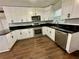 Modern kitchen with white cabinets, black countertops, and stainless steel appliances at 7035 Stone Wood Nw Dr, Kennesaw, GA 30152