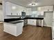 Modern kitchen with white cabinets, black countertops, and stainless steel appliances at 7035 Stone Wood Nw Dr, Kennesaw, GA 30152