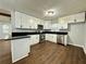 Modern kitchen with white cabinets, black countertops, and stainless steel appliances at 7035 Stone Wood Nw Dr, Kennesaw, GA 30152