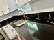 Kitchen with black countertops and stainless steel sink at 7035 Stone Wood Nw Dr, Kennesaw, GA 30152