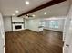 Spacious living room with hardwood floors, a fireplace, and high ceilings at 7035 Stone Wood Nw Dr, Kennesaw, GA 30152