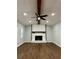 Living room with hardwood floors, fireplace, and ceiling fan at 7035 Stone Wood Nw Dr, Kennesaw, GA 30152