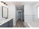 Modern bathroom with double vanity, soaking tub, and glass shower at 1170 Rose Terrace Cir, Loganville, GA 30052