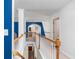 Upstairs hallway with blue walls and a wooden railing overlooking the lower level at 1170 Rose Terrace Cir, Loganville, GA 30052