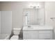 Well-lit bathroom with white vanity, large mirror, and tub with shower at 3742 Berkeley Xing, Duluth, GA 30096