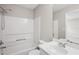 Bathroom featuring vanity, bathtub with shower, and a large mirror at 3742 Berkeley Xing, Duluth, GA 30096