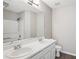 Well-lit bathroom featuring a tub, shower, and vanity with double sinks, and wood floor at 3742 Berkeley Xing, Duluth, GA 30096