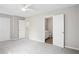 Bright bedroom featuring neutral walls, carpet, ceiling fan, and two doors leading to other rooms at 3742 Berkeley Xing, Duluth, GA 30096