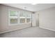 Bedroom with plush carpet, three windows, and a walk-in closet at 3742 Berkeley Xing, Duluth, GA 30096