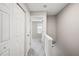 Hallway with white doors and neutral walls leading to carpeted bedroom with natural light at 3742 Berkeley Xing, Duluth, GA 30096