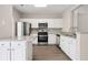 Modern kitchen with stainless steel appliances and granite countertops at 3742 Berkeley Xing, Duluth, GA 30096