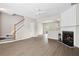 Stylish living room with fireplace, stairs, and views into kitchen at 3742 Berkeley Xing, Duluth, GA 30096