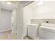 Convenient laundry room with washer, dryer, and shelving for storage at 3886 Cedar Trace Ln, Ellenwood, GA 30294