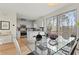 Open concept dining area with glass table and modern chairs, next to kitchen at 2445 Field Ne Way, Brookhaven, GA 30319