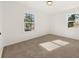 Bright bedroom with neutral walls, carpet, and two windows at 2920 Queens Ct, Norcross, GA 30071