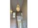 Elegant staircase with a glass and metal chandelier at 798 Ridgeland Trl, Clarkston, GA 30021