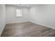 Spacious bedroom with wood-look flooring and a window at 1647 Raleigh Se Cir, Marietta, GA 30067