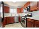 Well-equipped kitchen with wood cabinets and stainless steel appliances at 1647 Raleigh Se Cir, Marietta, GA 30067