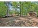 House nestled in a wooded area with a shed at 19 Roving Hills Cir, Cartersville, GA 30121