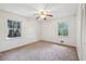 Well-lit bedroom with carpet flooring, ceiling fan and large windows at 19 Roving Hills Cir, Cartersville, GA 30121