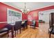 Red-walled dining room, hardwood floors, and a chandelier at 19 Roving Hills Cir, Cartersville, GA 30121