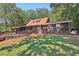 House exterior showcasing a large yard and deck at 19 Roving Hills Cir, Cartersville, GA 30121