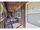 Inviting front porch with wooden railing and small table at 19 Roving Hills Cir, Cartersville, GA 30121
