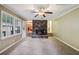 Gathering room featuring a brick fireplace and carpet flooring at 19 Roving Hills Cir, Cartersville, GA 30121