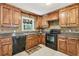 Kitchen with wood cabinets, granite countertops, and tile floors at 19 Roving Hills Cir, Cartersville, GA 30121
