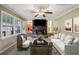 Living room features a brick fireplace and large windows at 19 Roving Hills Cir, Cartersville, GA 30121