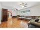 Hardwood floor living room with sectional sofa and two ceiling fans at 19 Roving Hills Cir, Cartersville, GA 30121