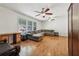 Hardwood floor living room with sectional sofa and two ceiling fans at 19 Roving Hills Cir, Cartersville, GA 30121