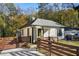 Quaint home featuring fenced front yard, mature trees, and inviting facade at 1018 Westmont Sw Rd, Atlanta, GA 30311