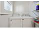 Laundry room with washer, dryer, and shelving at 1018 Westmont Sw Rd, Atlanta, GA 30311