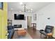 Bright living room features a modern fireplace with stone surround, hardwood floors, and stylish light fixture at 1018 Westmont Sw Rd, Atlanta, GA 30311