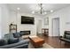 Modern living room with a fireplace, dark hardwood floors, and comfortable seating at 1018 Westmont Sw Rd, Atlanta, GA 30311
