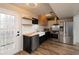 Modern kitchen with white cabinets, butcher block counters, and stainless steel appliances at 592 Waynes Ct, Atlanta, GA 30354