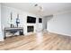 Living room with hardwood floors, fireplace, and built-in shelving at 592 Waynes Ct, Atlanta, GA 30354