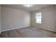 Bedroom with window, neutral walls, and carpet at 157 Parkview Place Dr, Mcdonough, GA 30253