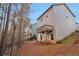 Home's back exterior with a deck and wooded backdrop at 157 Parkview Place Dr, Mcdonough, GA 30253